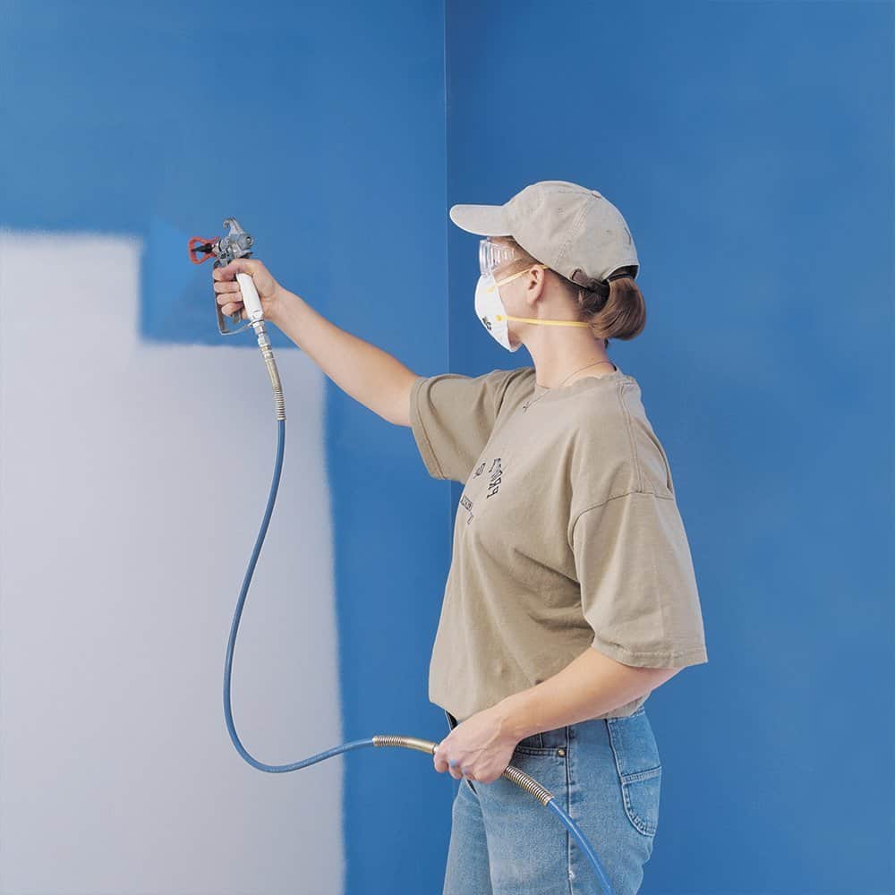 Lady using an airless paint sprayer machine