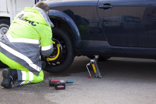 impact wrench removing a car tire lug nut